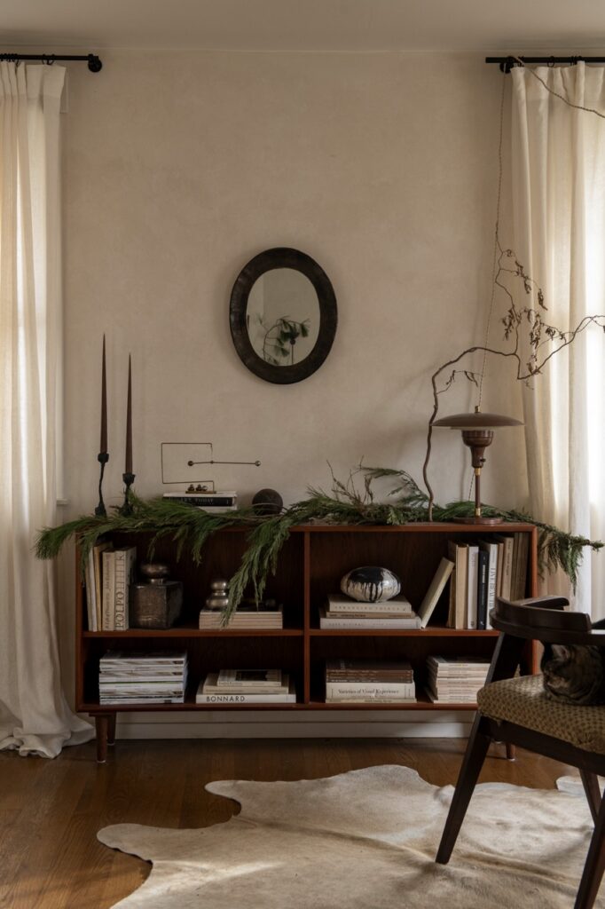 Foraged holiday decor on bookshelf, photographed by Erin Kelly.