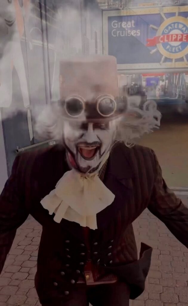 Actor in spooky costume with top hat and goggles, promoting Pittsburgh ghost tours.