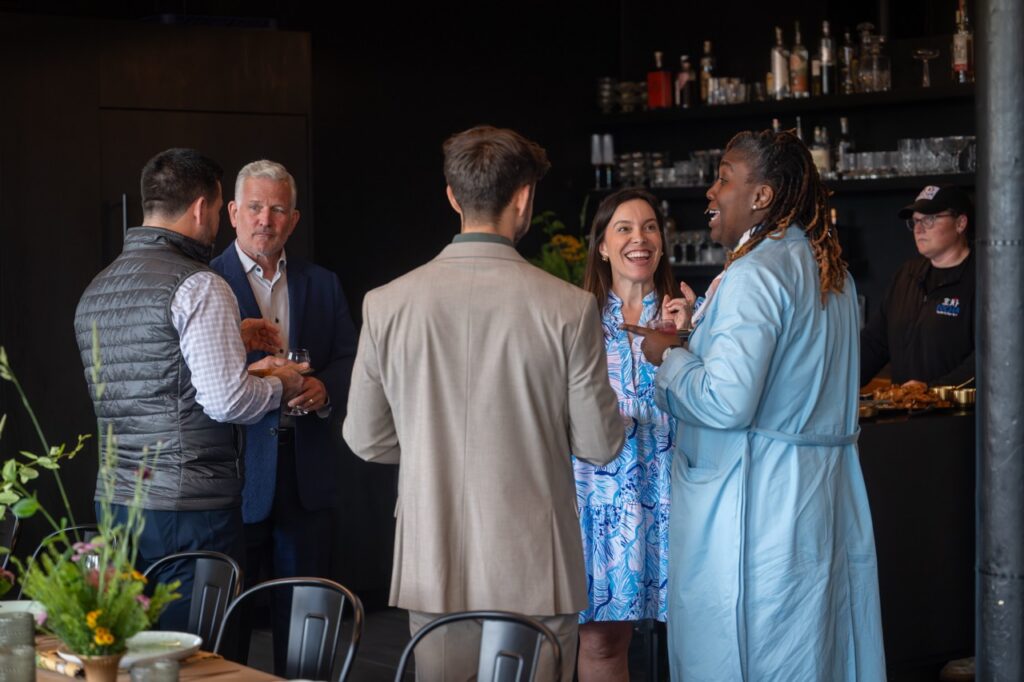 Pittsburgh leaders and Hello Neighbor members converse at an event