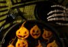 Jack O’Lantern Roasted Beets with Apple Cider Glaze A tray of roasted golden beet halves carved with jack o’lantern faces and drizzled with apple cider glaze on a platter.
