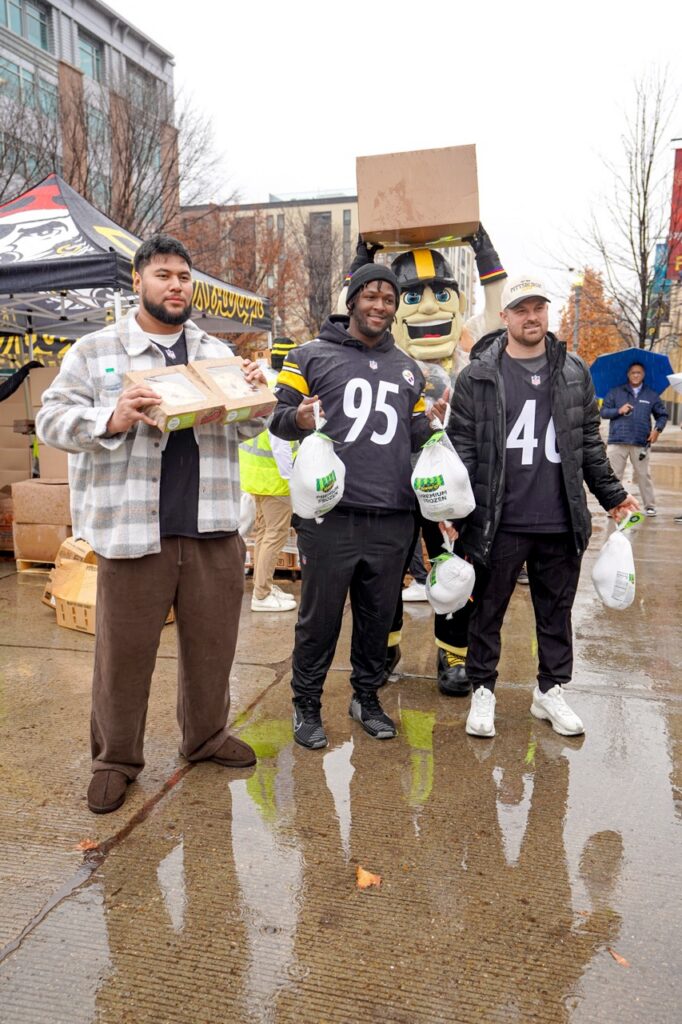 Pittsburgh Steelers players and mascot hold turkeys for KDKA Turkey Fund event