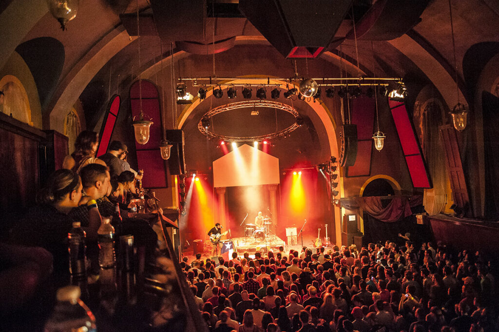 Live band performing on stage at Mr. Smalls Theatre with a large audience