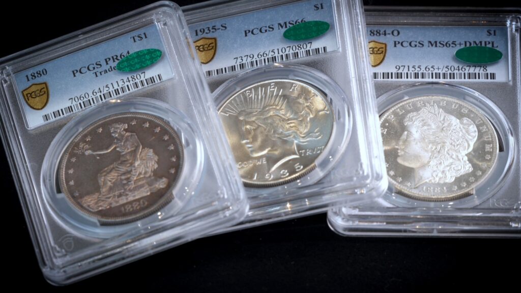 Three graded US silver coins: 1880 PCGS PR64, 1935 PCGS MS66, 1884-O PCGS MS65