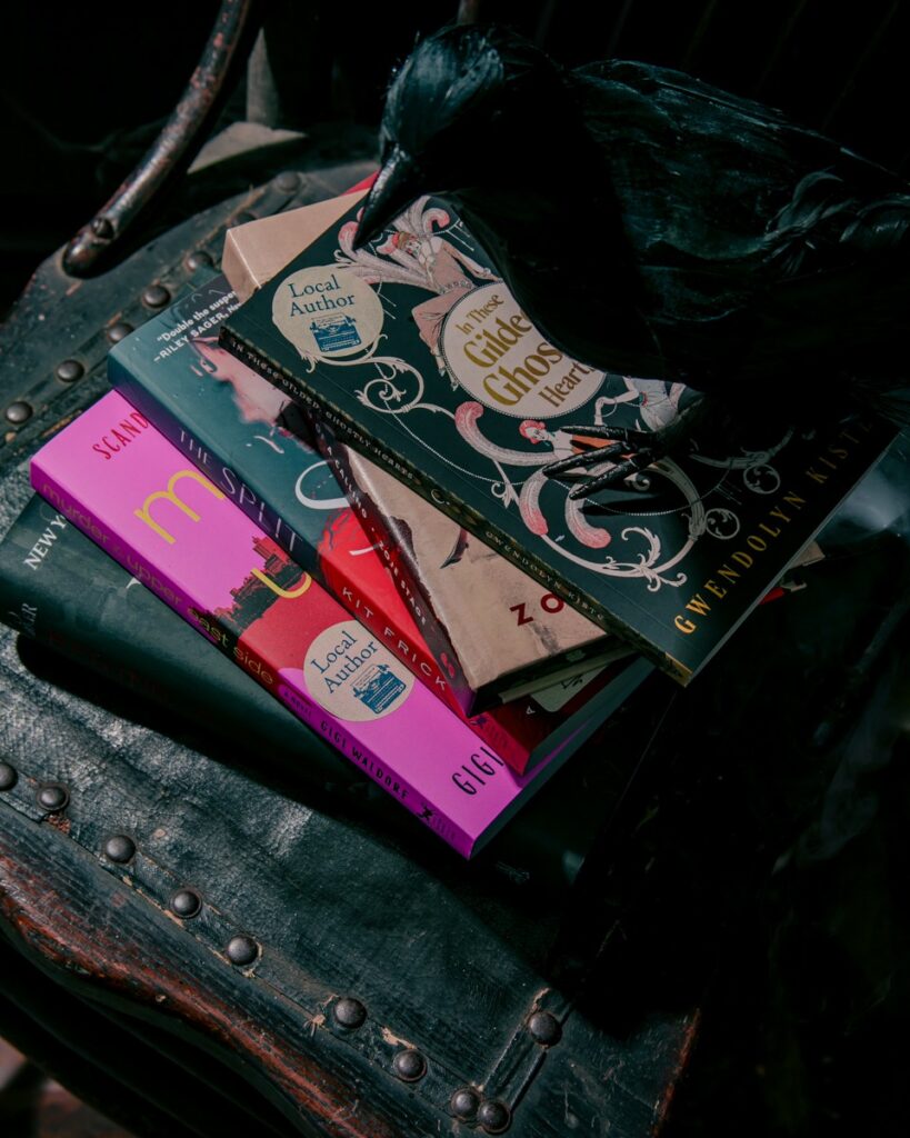 Stack of books by Pittsburgh horror authors, including "In These Gilded Ghosts" and "The Split.