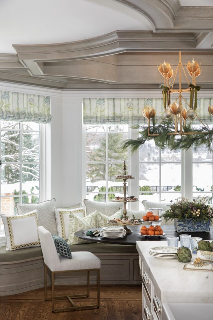 Luxurious holiday dining nook with floral decor and winter view.