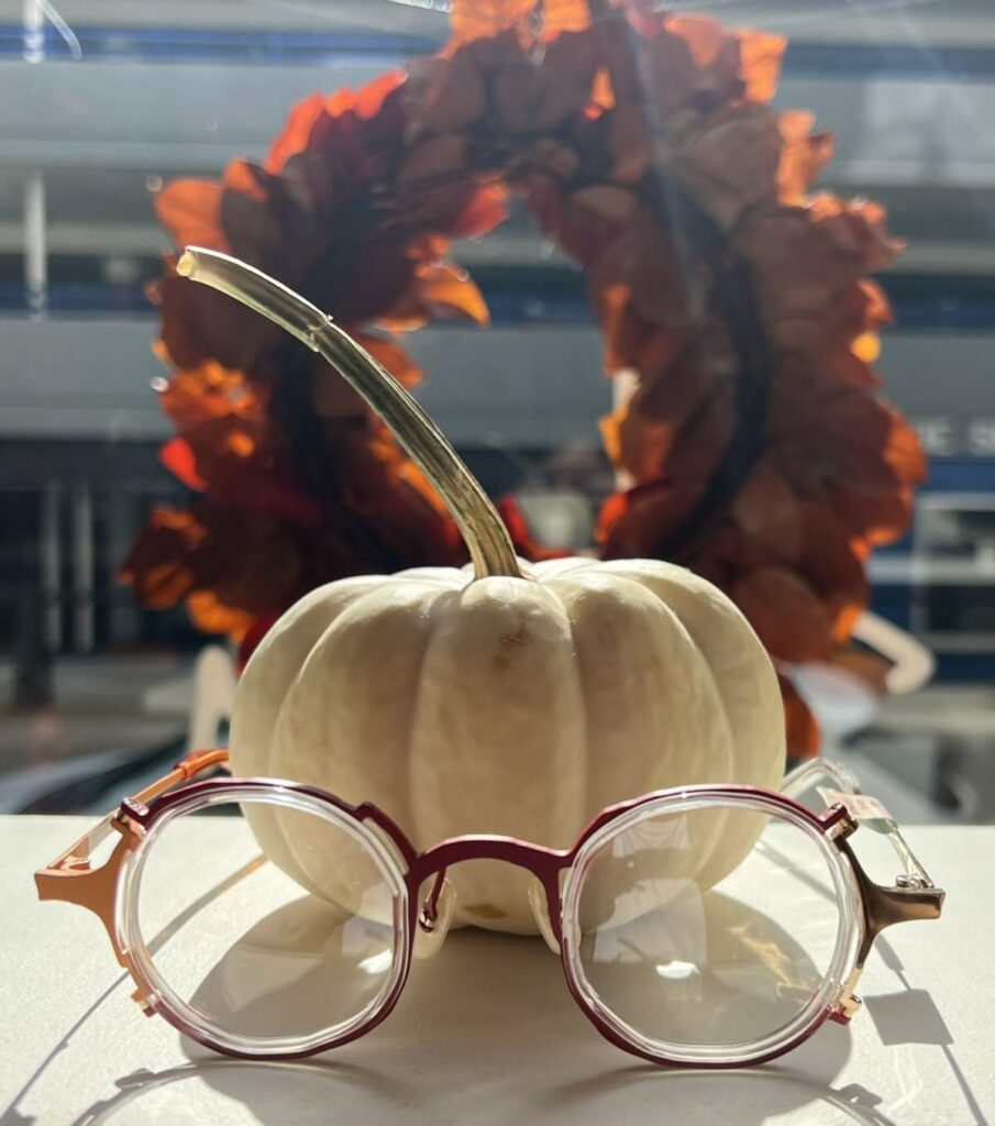 HeidiOptics glasses in front of a white pumpkin and autumn wreath