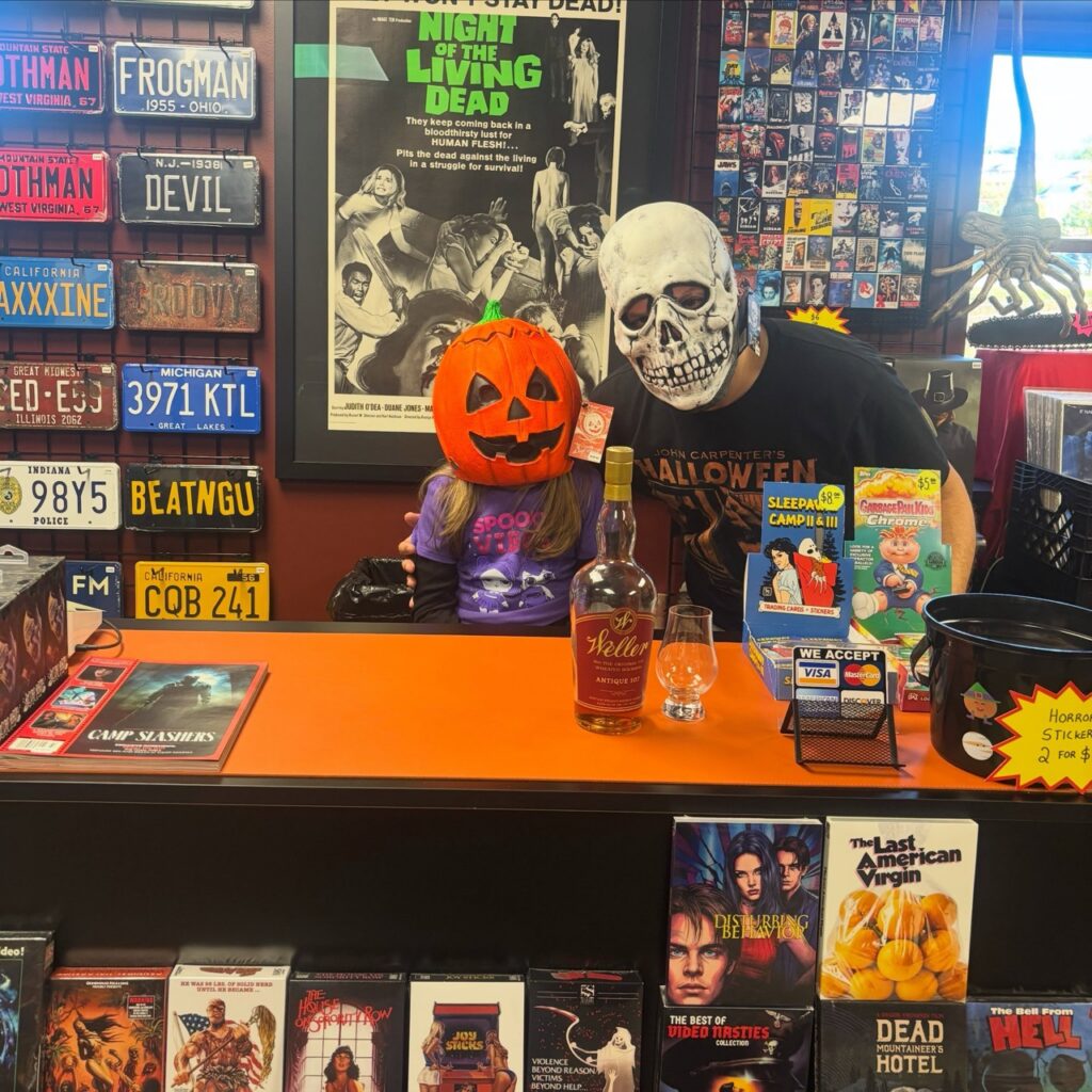 People in skull and pumpkin masks in a Pittsburgh horror shop